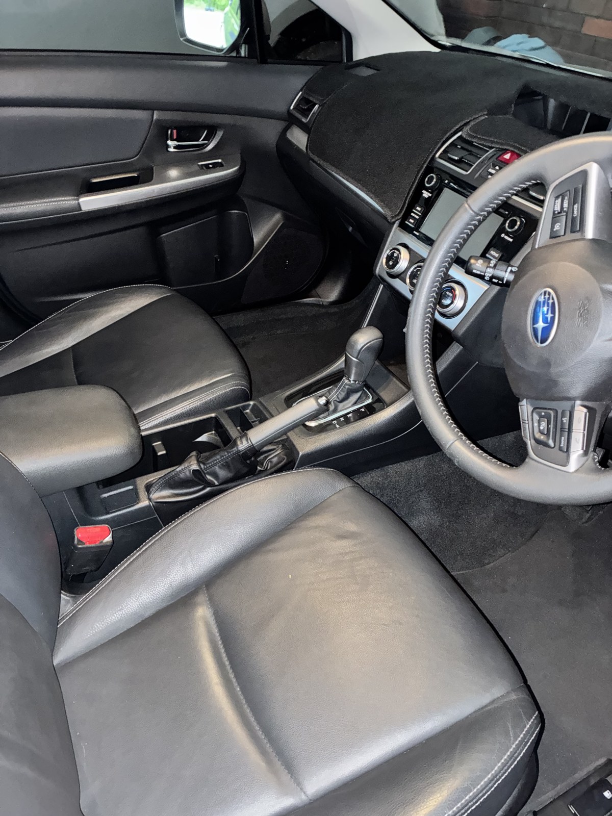 Spotless Subaru interior with conditioned leather seats and clean dash after detailing