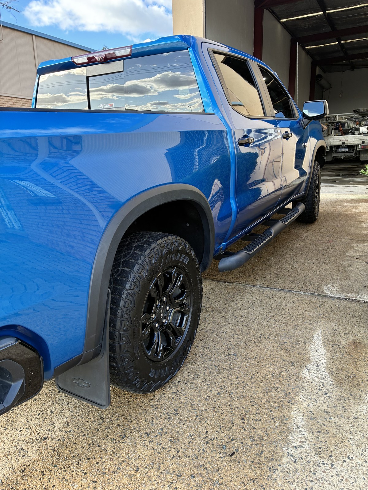 Blue Chevrolet Silverado with a deep glossy finish after a Squeaks detail
